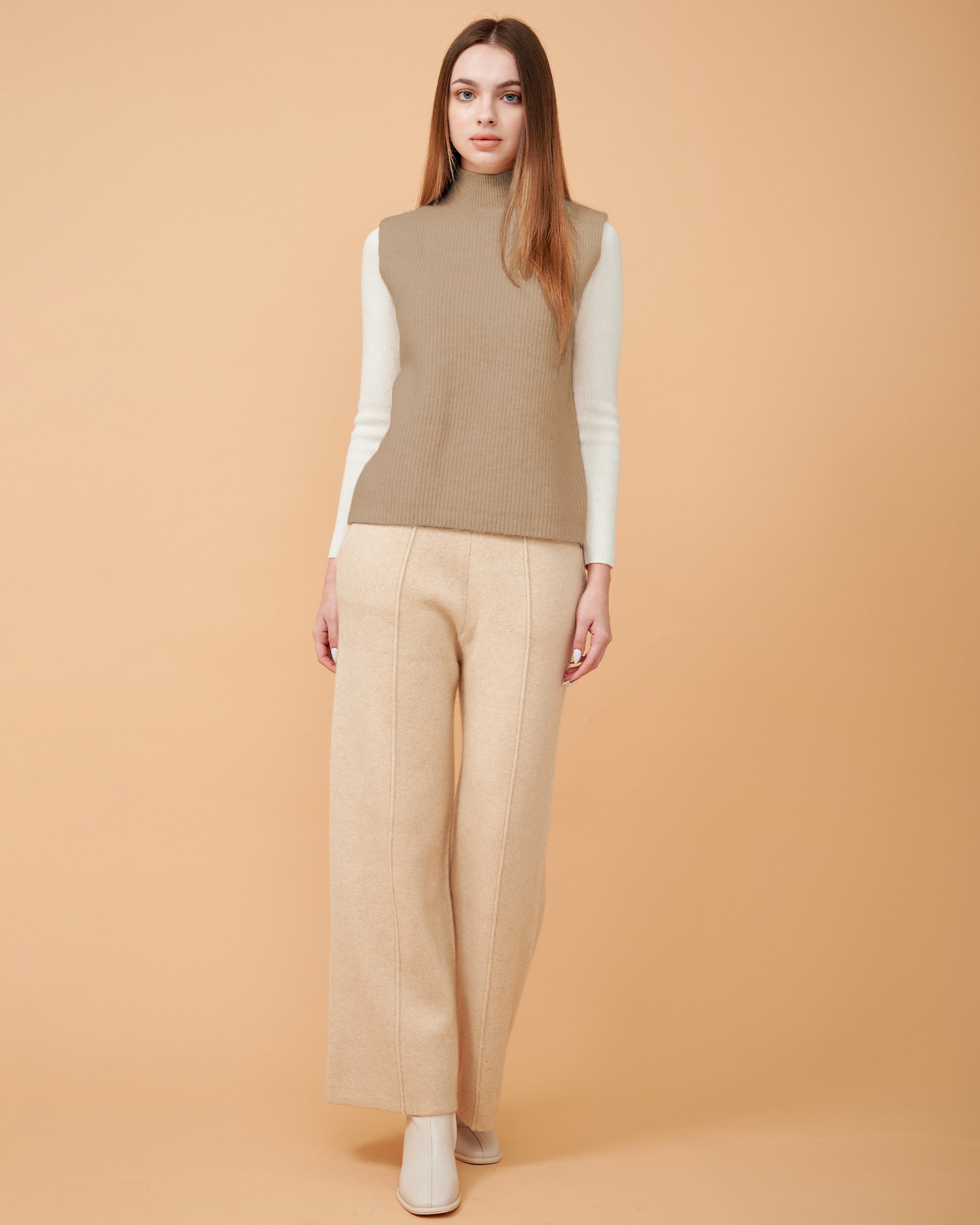 A front view of a cashmere vest coat in khaki showing the straight-sided design , Very smooth cashmere design