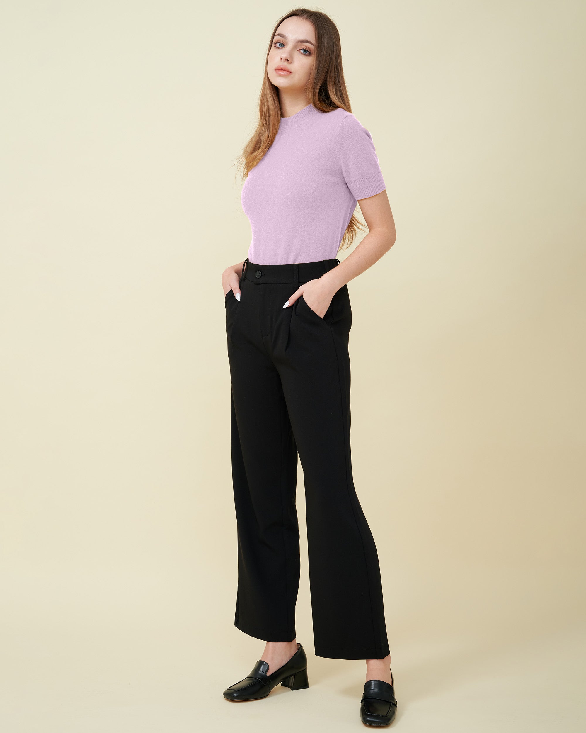 A front view of a cashmere pullover in pink showing the fit with suitable loafer , Fully cashmere , soft and comfy