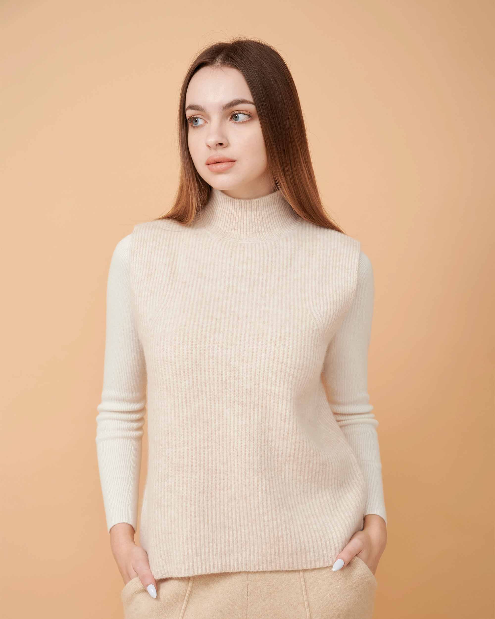 A front view of a cashmere vest coat in creame showing the straight-sided design , Very smooth cashmere design