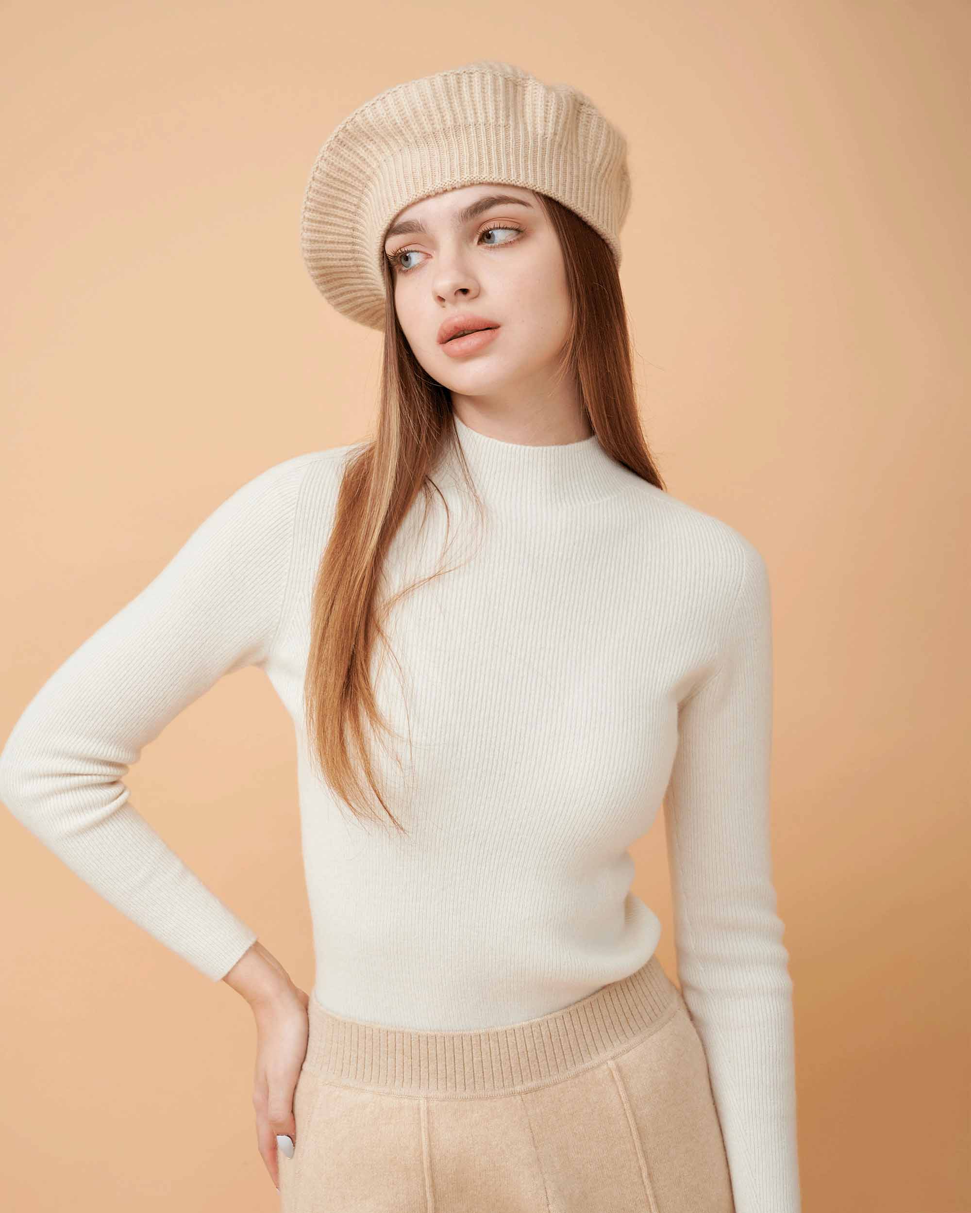 A front view of a plain cashmere sweater in white showing the fit , 100% Cashmere ,DAVINII