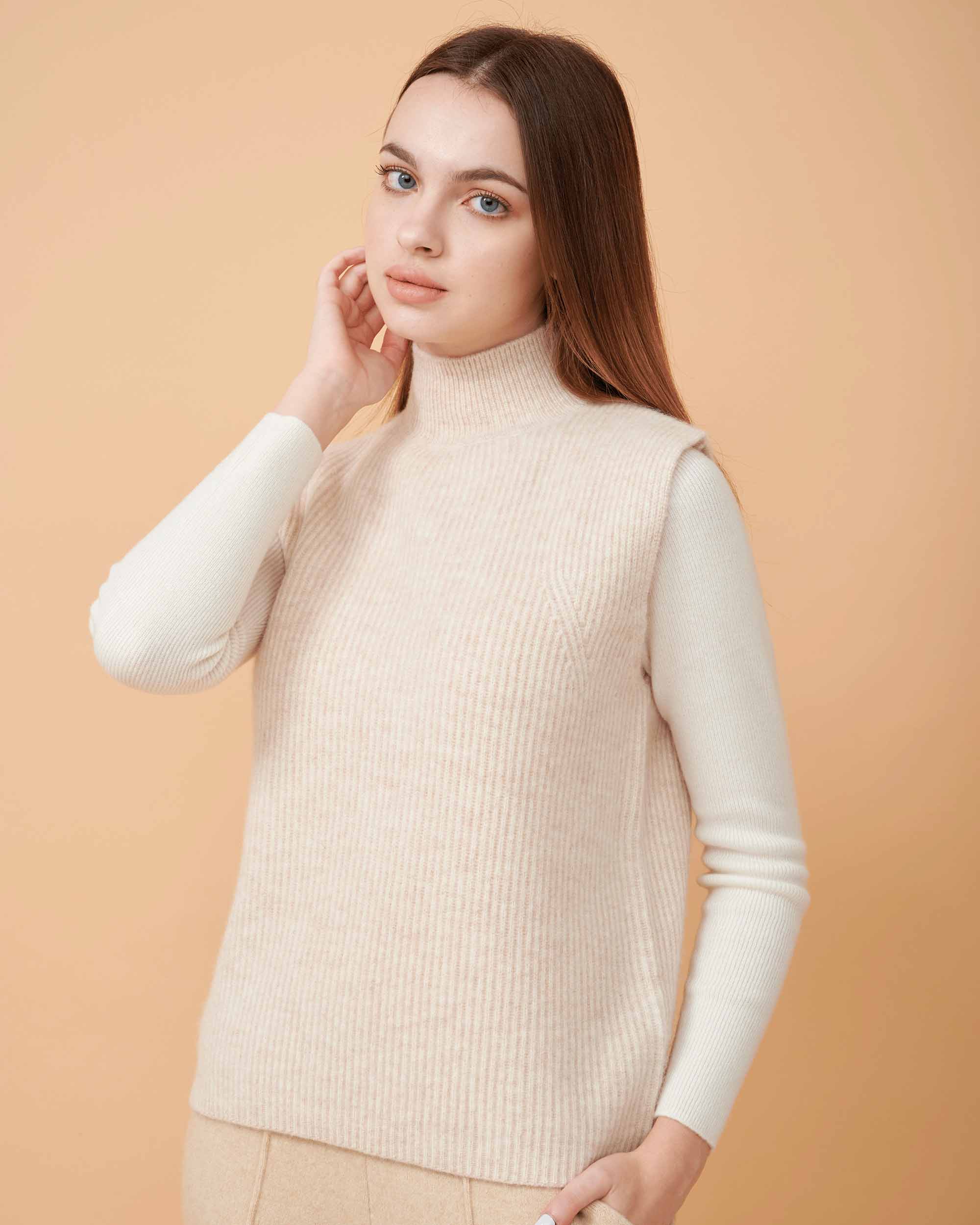 A front view of a cashmere vest coat in creame showing the straight-sided design , Very smooth cashmere design