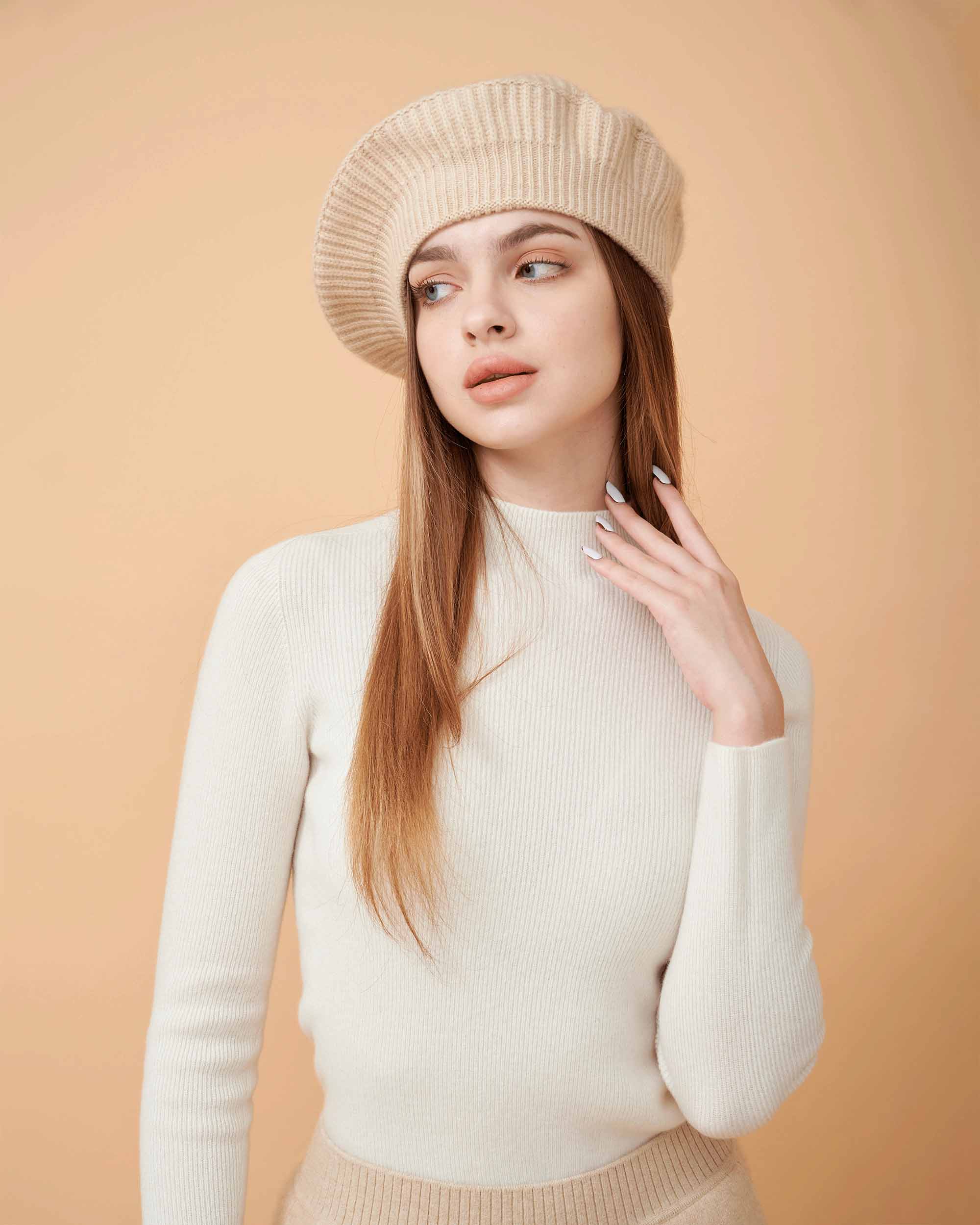 A front view of a plain cashmere sweater in white showing the fit , 100% Cashmere ,DAVINII