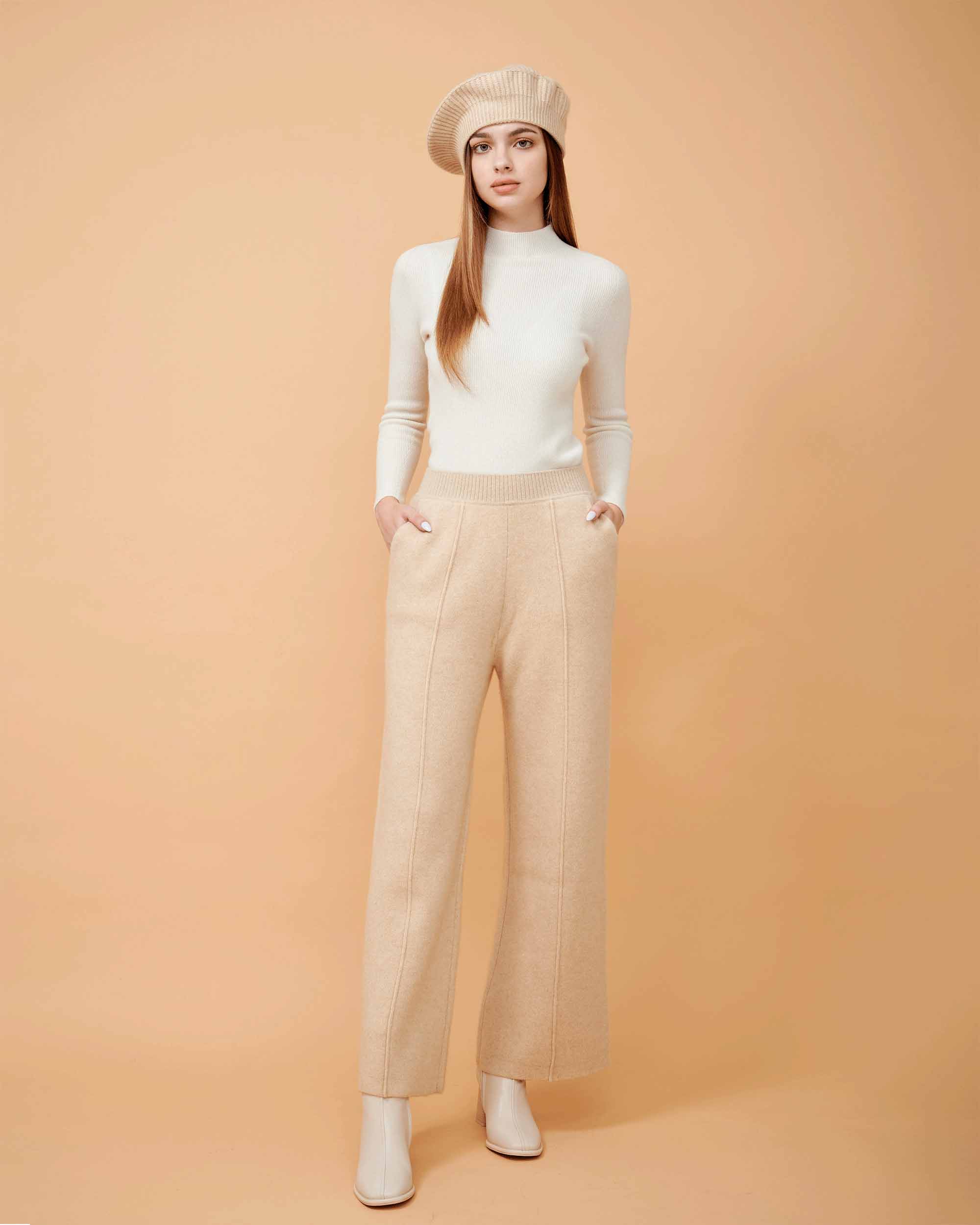 A front view of a plain cashmere sweater in white showing the fit , 100% Cashmere ,DAVINII