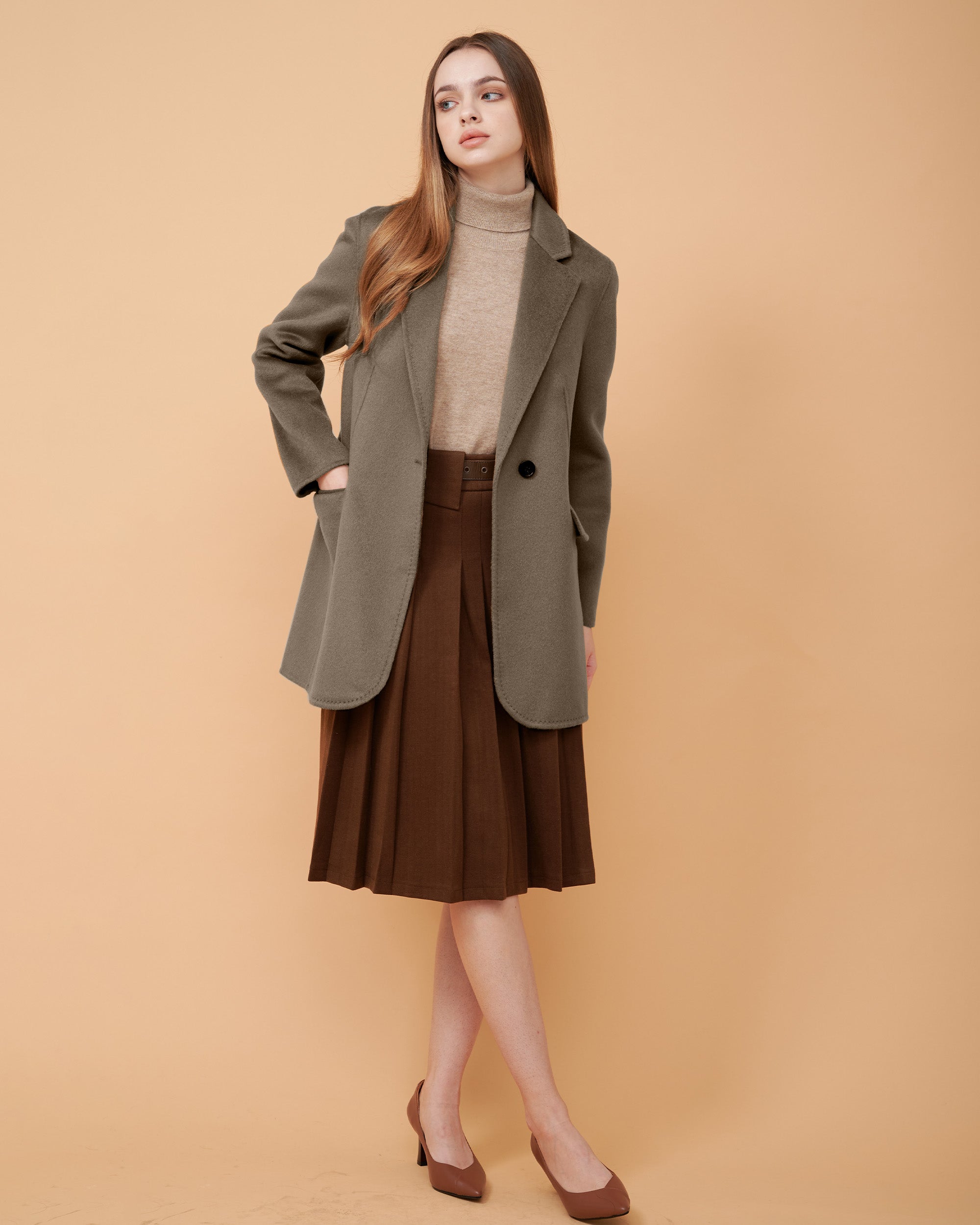 A woman wearing a beaver cashmere blazer and a matching wool sweater ,DAVINII