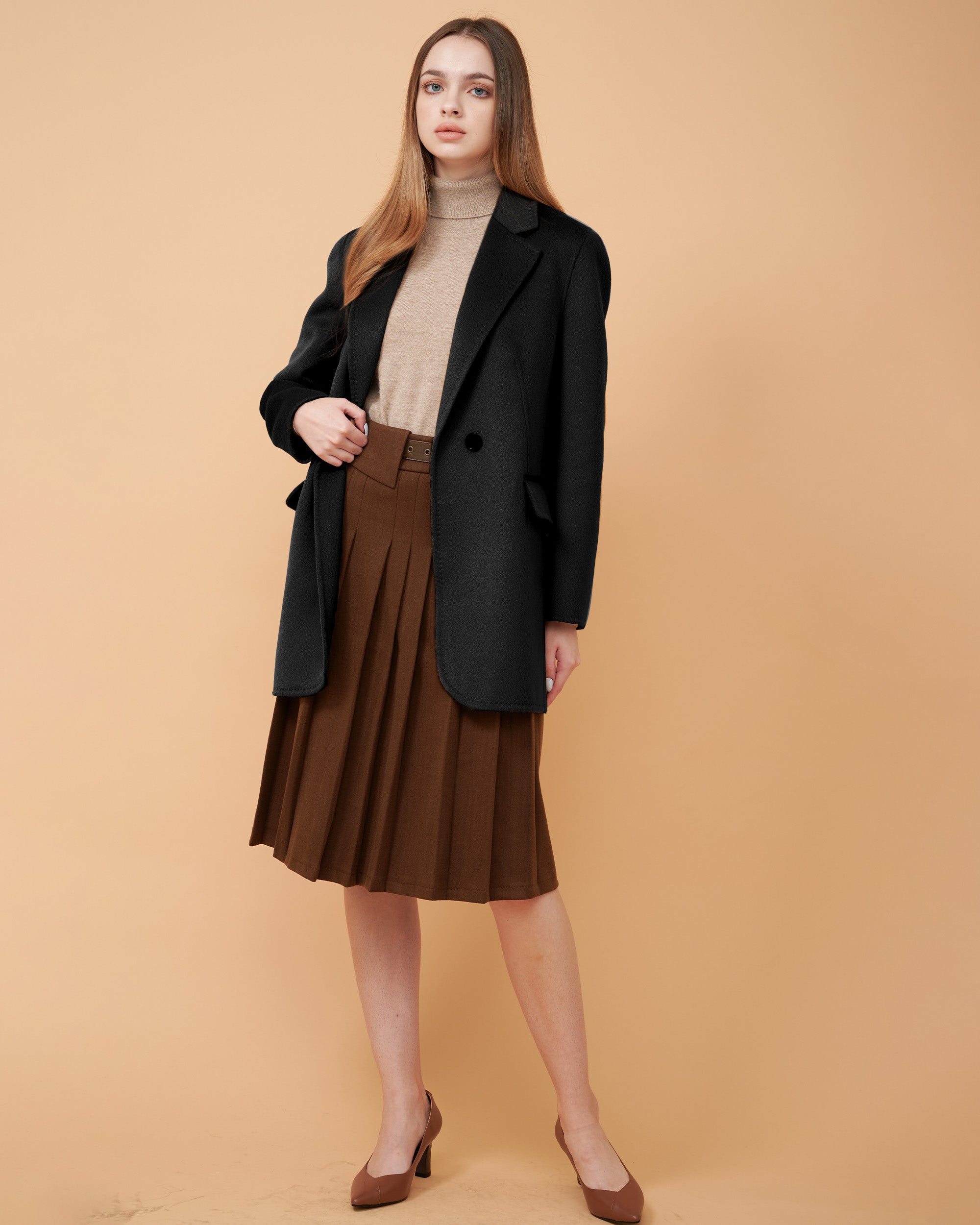 A woman wearing a black cashmere blazer and a matching wool sweater ,DAVINII