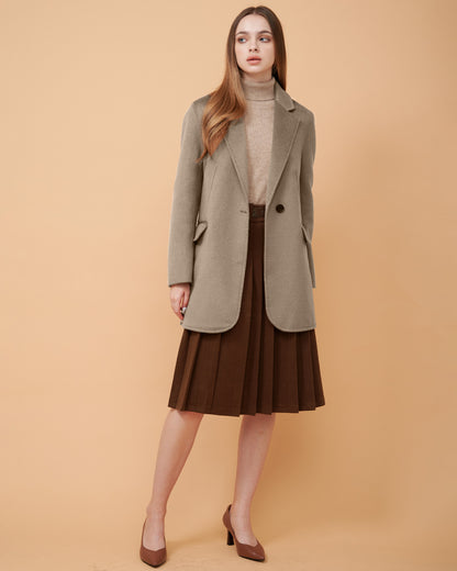 A woman wearing a cafee au lait cashmere blazer and a matching wool sweater ,DAVINII