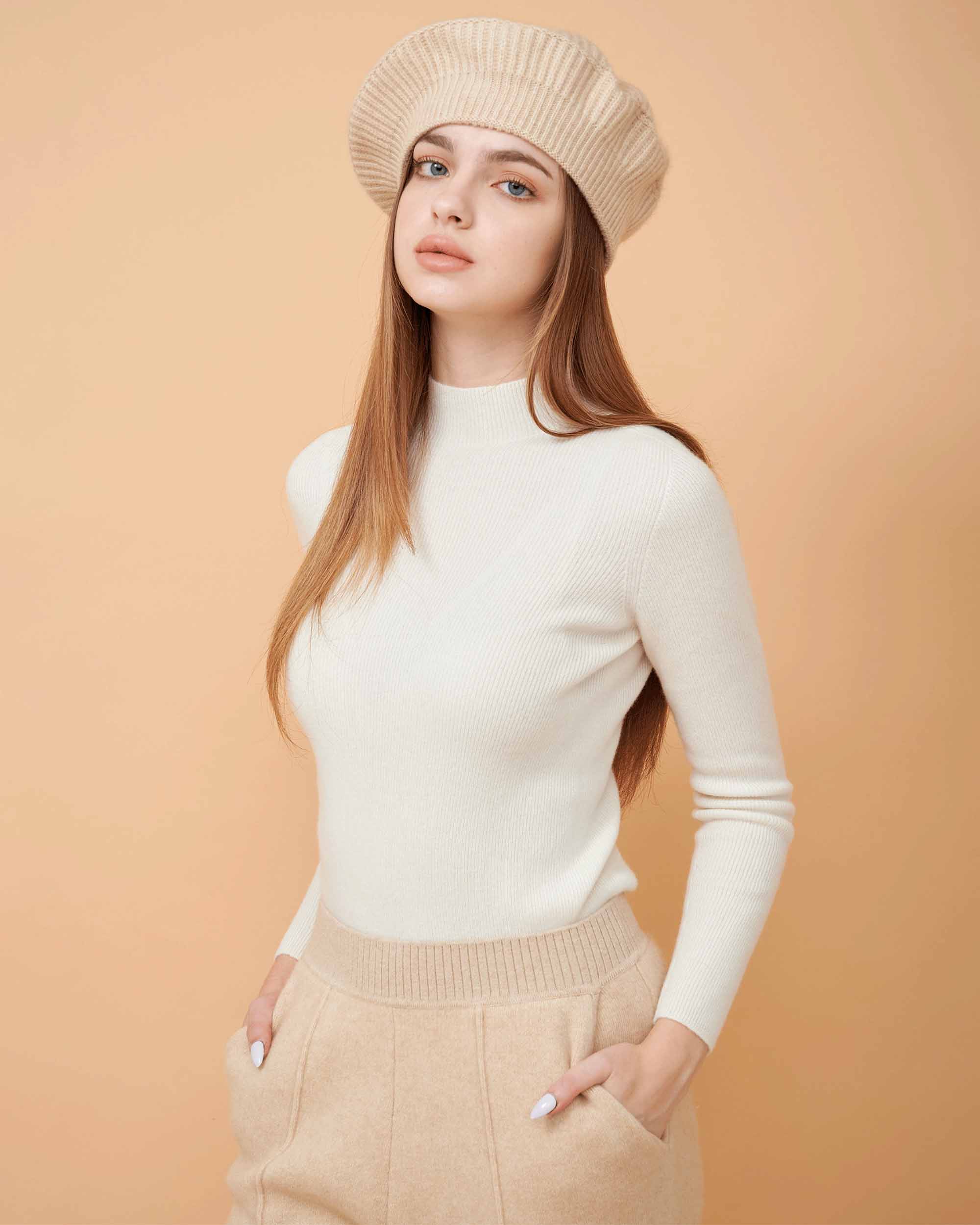 A front view of a plain cashmere sweater in white showing the fit , 100% Cashmere ,DAVINII