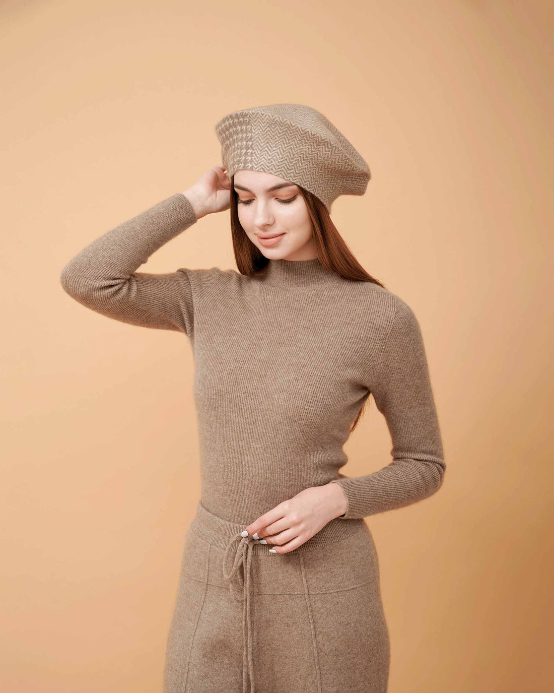 A front view of a plain cashmere sweater in taupe showing the fit , 100% Cashmere ,DAVINII