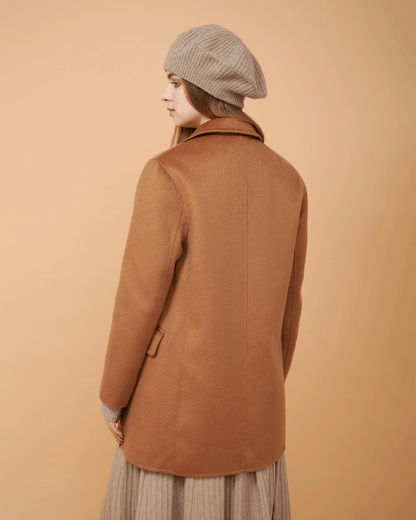 A back view of woman wearing a clay cashmere blazer and a matching wool sweater ,DAVINII